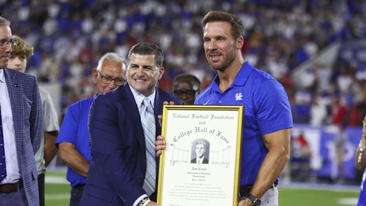 Sep 14, 2024; Lexington, Kentucky, USA; Former Kentucky Wildcats quarterback Tim Couch (right) is inducted into the Hall of Fam during halftime against Georgia Bulldogs at Kroger Field. Georgia won 13-12. Mandatory Credit: Carter Skaggs-Imagn Images