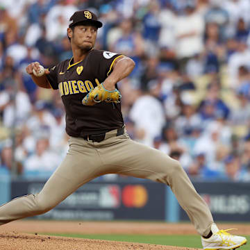 Oct 11, 2024; Los Angeles, California, USA; San Diego Padres pitcher Yu Darvish (11) pitches against the Los Angeles Dodgers in the first inning during game five of the NLDS for the 2024 MLB Playoffs at Dodger Stadium. Mandatory Credit: Kiyoshi Mio-Imagn Images