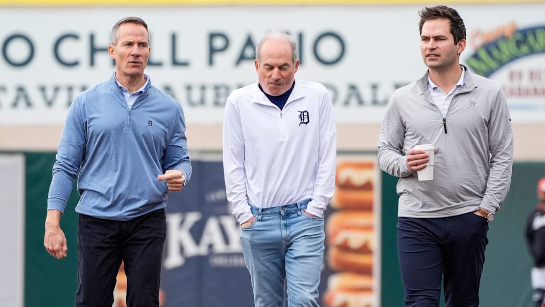Detroit Tigers owner Chris Ilitch, left, talks to Rob Harris, center, and president of baseball operation Scott Harris during spring training at Joker Marchant Stadium in Lakeland, Fla. on Thursday, Feb. 20, 2025.