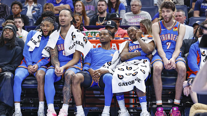 Apr 10, 2024; Oklahoma City, Oklahoma, USA; (L-R) Oklahoma City Thunder guard Isaiah Joe (11) and forward Jaylin Williams (6) and guard Shai Gilgeous-Alexander (2) and forward Jalen Williams (8) and forward Chet Holmgren (7) watch their team play against the San Antonio Spurs during the second half at Paycom Center. Mandatory Credit: Alonzo Adams-Imagn Images