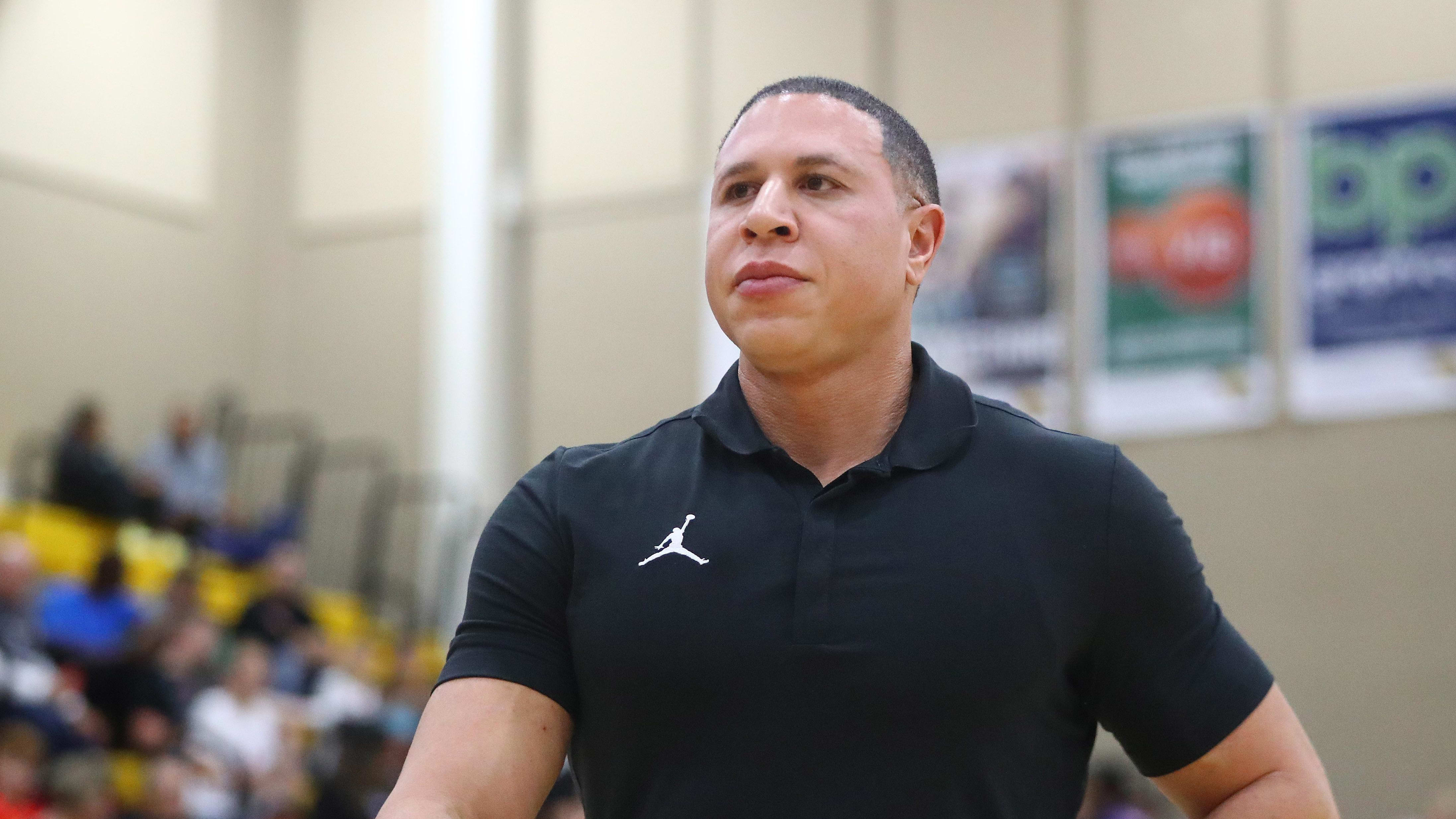 Mike Bibby coaches a high school basketball game.