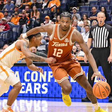 Mar 14, 2025; Nashville, TN, USA;  Texas Longhorns guard Tramon Mark (12) drives to the basket past Tennessee Volunteers guard Chaz Lanier (2) during the second half at Bridgestone Arena. Mandatory Credit: Steve Roberts-Imagn Images