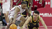Wisconsin guard Kamari McGee (4) and Oregon guard Jackson Shelstad (3) dive for the ball during the first half of their game Saturday, February 22, 2025 at the Kohl Center in Madison, Wisconsin.