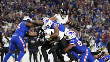 Sep 7, 2025; Orchard Park, New York, USA;  Buffalo Bills defensive end Greg Rousseau (50) tackles Baltimore Ravens quarterback Lamar Jackson (8) during the first quarter at Highmark Stadium. Mandatory Credit: Gregory Fisher-Imagn Images