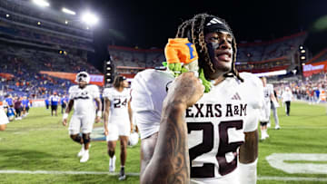 Sep 14, 2024; Gainesville, Florida, USA; Texas A&M Aggies defensive back Will Lee III (26) holds a Florida Gator plush toy after defeating the Florida Gators at Ben Hill Griffin Stadium. Mandatory Credit: Matt Pendleton-Imagn Images
