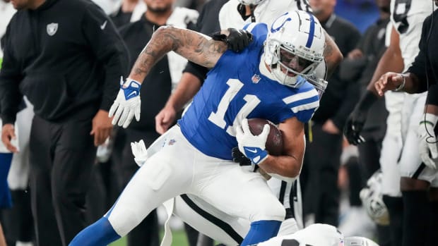 Colts wide receiver Michael Pittman Jr. (blue jersey with white pants/helmet) fights for extra yards after making the catch. 