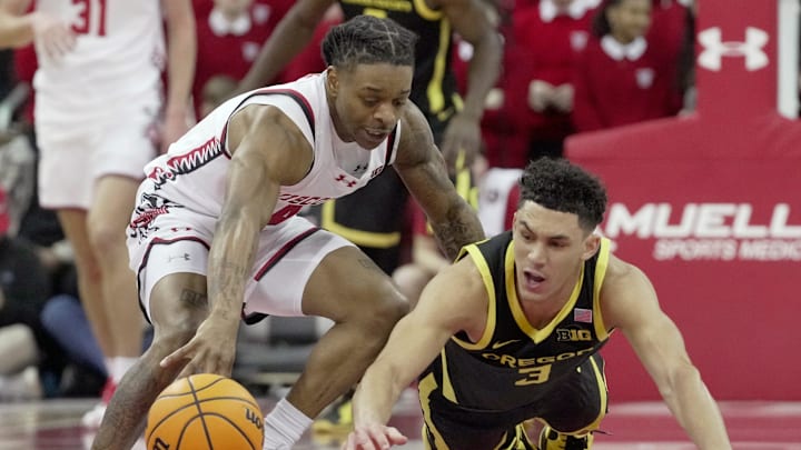 Wisconsin guard Kamari McGee (4) and Oregon guard Jackson Shelstad (3) dive for the ball during the first half of their game Saturday, February 22, 2025 at the Kohl Center in Madison, Wisconsin. Wisconsin guard Kamari McGee (4) and Oregon guard Jackson Shelstad (3) dive for the ball during the first half of their game Saturday, February 22, 2025 at the Kohl Center in Madison, Wisconsin.