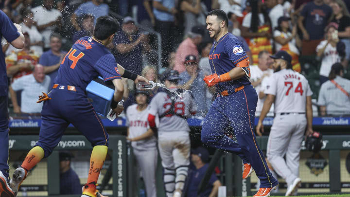 Aug 19, 2024; Houston, Texas, USA; Boston Red Sox relief pitcher Kenley Jansen (74) walks off the field as Houston Astros catcher Yainer Diaz (21) celebrates with teammates after hitting a walk-off home run during the ninth inning at Minute Maid Park. Mandatory Credit: Troy Taormina-USA TODAY Sports