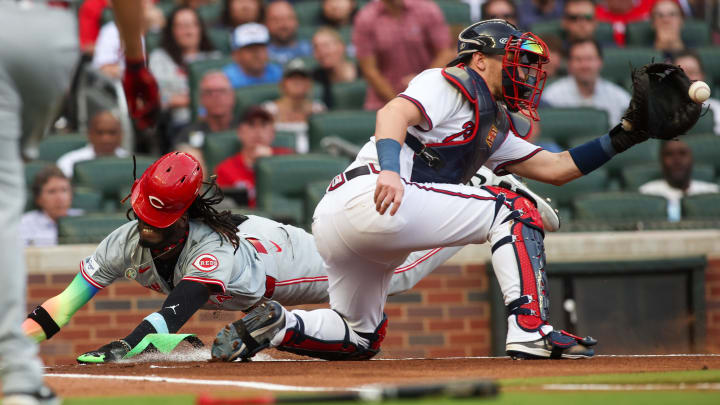 Jul 22, 2024; Atlanta, Georgia, USA; Cincinnati Reds shortstop Elly De La Cruz (44) slides safely past Atlanta Braves catcher Sean Murphy (12) in the first inning at Truist Park. Mandatory Credit: Brett Davis-USA TODAY Sports