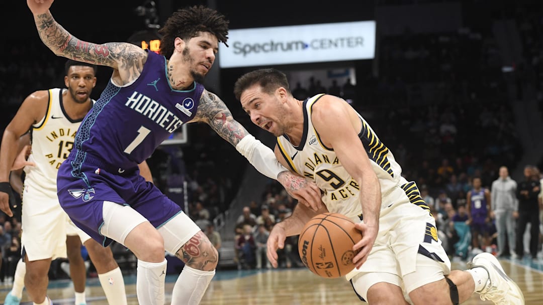 Jan 8, 2026; Charlotte, North Carolina, USA;  Indiana Pacers guard T.J. McConnell (9) drives past Charlotte Hornets guard LaMelo Ball (1) during the second half at the Spectrum Center. Mandatory Credit: Sam Sharpe-Imagn Images