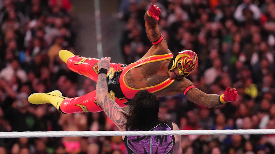 Apr 1, 2023; Inglewood, CA, USA; Dominik Mysterio (black/purple attire) and Rey Mysterio (pink/yellow attire) during Wrestlemania Night 1 at SoFi Stadium. Mandatory Credit: Joe Camporeale-Imagn Images
