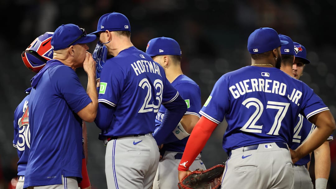 May 7, 2025; Anaheim, California, USA; Toronto Blue Jays relief pitcher Jeff Hoffman (23) talks to pitching coach Pete Walker during the ninth inning against the Los Angeles Angels at Angel Stadium.