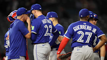 May 7, 2025; Anaheim, California, USA; Toronto Blue Jays relief pitcher Jeff Hoffman (23) talks to pitching coach Pete Walker during the ninth inning against the Los Angeles Angels at Angel Stadium.