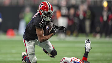 Dec 22, 2024; Atlanta, Georgia, USA; Atlanta Falcons wide receiver Darnell Mooney (1) flies over a tackle by New York Giants safety Jason Pinnock (27) at Mercedes-Benz Stadium. Mandatory Credit: Dale Zanine-Imagn Images