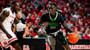 Dec 20, 2023; Lincoln, Nebraska, USA; North Dakota Fighting Hawks forward B.J. Omot (20) drives against Nebraska Cornhuskers forward Juwan Gary (4) during the second half at Pinnacle Bank Arena. Mandatory Credit: Dylan Widger-Imagn Images