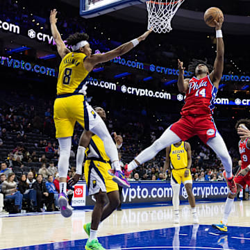Dec 13, 2024; Philadelphia, Pennsylvania, USA; Philadelphia 76ers guard Ricky Council IV (14) drives for a shot against Indiana Pacers forward Enrique Freeman (8) during the fourth quarter at Wells Fargo Center. Mandatory Credit: Bill Streicher-Imagn Images