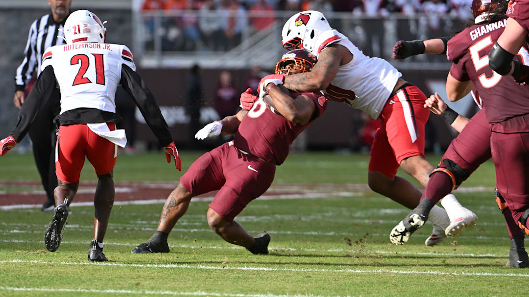 Louisville Cardinals defensive lineman Rene Konga (90) tackles Virginia Tech Hokies running back Terion Stewart (8) during the second quarter at Lane Stadium last season.