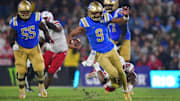  UCLA Bruins quarterback Nico Iamaleava moments before being tripped up by Nebraska Cornhuskers linebacker Dylan Rogers.