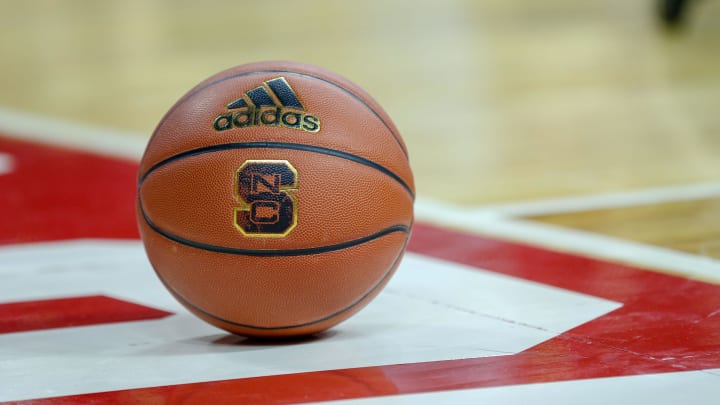 Feb 20, 2019; Raleigh, NC, USA; Basketball with the North Carolina State Wolfpack logo sits on the court during a timeout as the Wolfpack play the Boston College Eagles in the first half at PNC Arena. The North Carolina State Wolfpack won 89-80. 