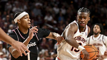 Mar 4, 2025; College Station, Texas, USA; Auburn Tigers guard Miles Kelly (13) drives against Texas A&M Aggies guard Zhuric Phelps (1) during the second half at Reed Arena. Mandatory Credit: Maria Lysaker-Imagn Images 