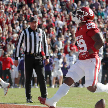 Nov 24, 2023; Norman, Oklahoma, USA; Oklahoma Sooners running back Tawee Walker (29) runs for a touchdown against TCU Horned Frogs linebacker Jamoi Hodge (6) at Gaylord Family-Oklahoma Memorial Stadium. Mandatory Credit: Bryan Terry-USA TODAY Sports