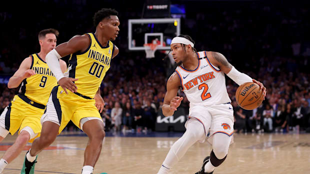 New York Knicks guard Miles McBride controls the ball against Indiana Pacers guard Bennedict Mathurin