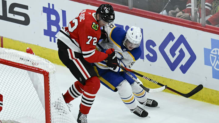 Oct 19, 2024; Chicago, Illinois, USA;  Chicago Blackhawks defenseman Alex Vlasic (72) fights for the puck against Buffalo Sabres left wing Zach Benson (9) during the third period at the United Center. Mandatory Credit: Matt Marton-Imagn Images