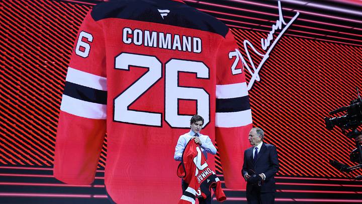 Jun 26, 2026; Buffalo, New York, USA; Alexander Command reacts beside NHL commissioner Gary Bettman after being selected with the twelfth pick in the first round of the 2026 NHL Draft by the New Jersey Devils at KeyBank Center. Mandatory Credit: Timothy T. Ludwig-Imagn Images