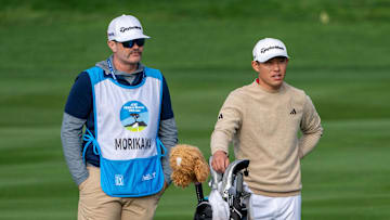 February 2, 2025; Pebble Beach, California, USA; Collin Morikawa (right) and caddie JJ Jakovac (left) on the second hole during the final round of the AT&T Pebble Beach Pro-Am golf tournament at Pebble Beach Golf Links. Mandatory Credit: Kyle Terada-Imagn Images