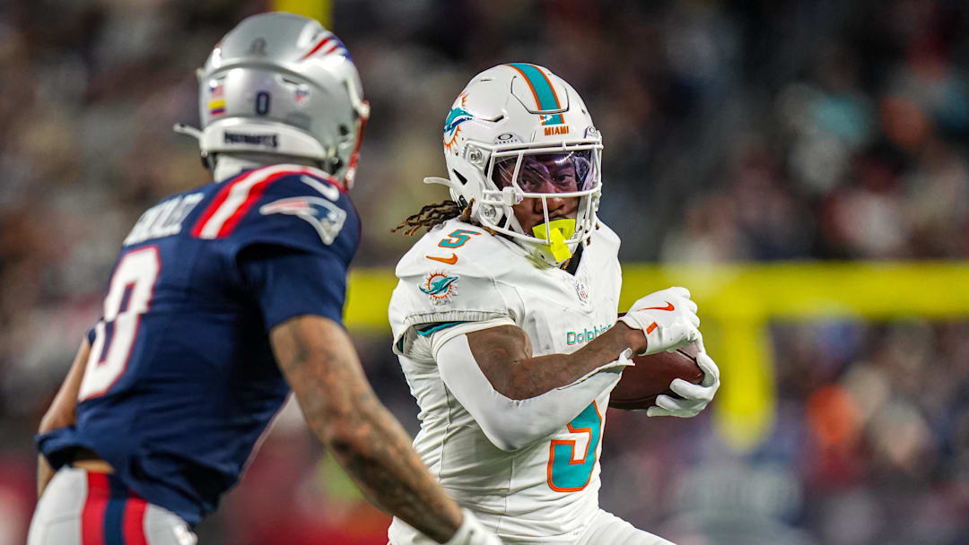 Miami Dolphins running back Jaylen Wright runs the ball against New England Patriots cornerback Christian Gonzalez during the second quarter at Gillette Stadium in the 2025 season finale.