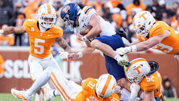 UTEP quarterback JP Pickles (19) tries to escape Tennessee defensive lineman Caleb Herring (31), Tennessee linebacker Ben Bolton (33) and Tennessee defensive back Christian Harrison (5) during a college football game between Tennessee and UTEP at Neyland Stadium in Knoxville, Tenn., Saturday, Nov. 23, 2024.