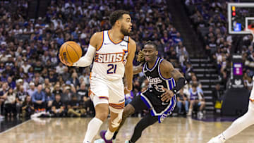 Apr 13, 2025; Sacramento, California, USA;  Phoenix Suns guard Tyus Jones (21) controls the ball as Sacramento Kings guard Keon Ellis (23) defends during the third quarter at Golden 1 Center. Mandatory Credit: John Hefti-Imagn Images
