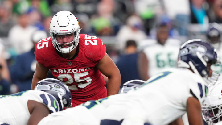 Jan 7, 2024; Glendale, Arizona, USA; Arizona Cardinals linebacker Zaven Collins (25) looks down Seattle Seahawks quarterback Geno Smith (7) during the second half at State Farm Stadium. Mandatory Credit: Joe Camporeale-USA TODAY Sports