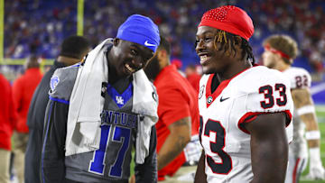 Sep 14, 2024; Lexington, Kentucky, USA; Kentucky Wildcats wide receiver Hardley Gilmore IV (17) and Georgia Bulldogs running back Chauncey Bowens (33) share a laugh after game at Kroger Field. Georgia won 13-12. Mandatory Credit: Carter Skaggs-Imagn Images