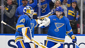 Mar 16, 2024; St. Louis, Missouri, USA;  St. Louis Blues center Jordan Kyrou (25) celebrates with goaltender Jordan Binnington (50) after the Blues defeated the Minnesota Wild in shoot outs at Enterprise Center. Mandatory Credit: Jeff Curry-Imagn Images