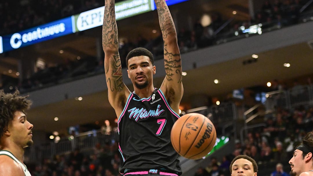 Feb 24, 2026; Milwaukee, Wisconsin, USA;  Miami Heat center Kel'el Ware (7) dunks the ball against Milwaukee Bucks center Jericho Sims (00) and guard Ryan Rollins (13) in the third quarter at Fiserv Forum. Mandatory Credit: Benny Sieu-Imagn Images