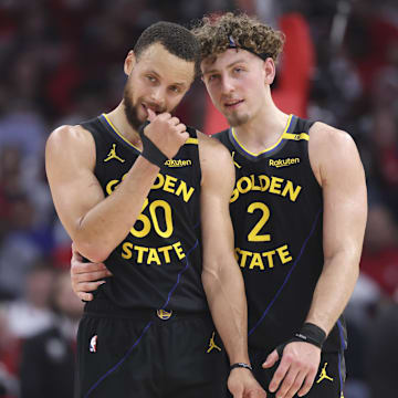 May 4, 2025; Houston, Texas, USA; Golden State Warriors guard Stephen Curry (30) and guard Brandin Podziemski (2) talk during a timeout during game seven of first round for the 2025 NBA Playoffs against the Houston Rockets at Toyota Center. Mandatory Credit: Troy Taormina-Imagn Images