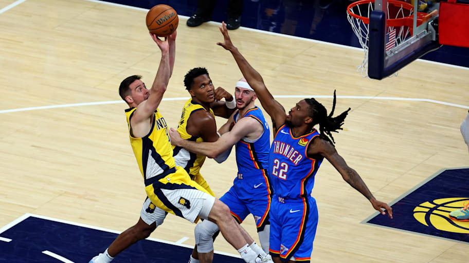 T.J. McConnell shoots the ball against Cason Wallace.