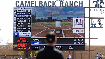 Mar 2, 2025; Phoenix, Arizona, USA; An umpire looks at the Jumbotron during an automated ball-strike challenge aka ABS in the Los Angeles Dodgers game against the Chicago White Sox during spring training at Camelback Ranch-Glendale. Mandatory Credit: Mark J. Rebilas-Imagn Images