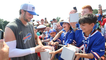Bills quarterback Josh Allen signs autographs for fans following practice on day seven.