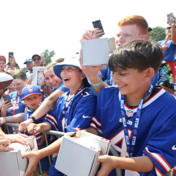 Bills quarterback Josh Allen signs autographs for fans following practice on day seven.