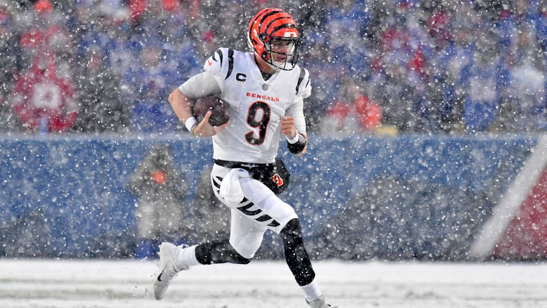 Jan 22, 2023; Orchard Park, New York, USA; Cincinnati Bengals quarterback Joe Burrow (9) runs with the ball against the Buffalo Bills during the second quarter of an AFC divisional round game at Highmark Stadium. Mandatory Credit: Mark Konezny-Imagn Images