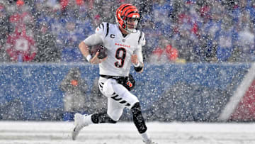 Jan 22, 2023; Orchard Park, New York, USA; Cincinnati Bengals quarterback Joe Burrow (9) runs with the ball against the Buffalo Bills during the second quarter of an AFC divisional round game at Highmark Stadium. Mandatory Credit: Mark Konezny-Imagn Images