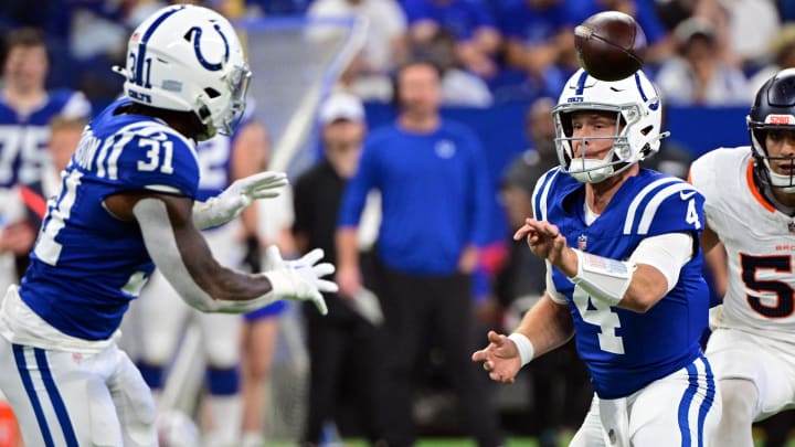 Aug 11, 2024; Indianapolis, Indiana, USA; Indianapolis Colts quarterback Sam Ehlinger (4) pitches the ball to Indianapolis Colts running back Tyler Goodson (31) during the second quarter at Lucas Oil Stadium. Mandatory Credit: Marc Lebryk-USA TODAY Sports