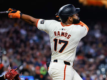 Aug 19, 2024; San Francisco, California, USA; San Francisco Giants outfielder Heliot Ramos (17) hits an RBI sac fly during the fifth inning against the Chicago White Sox at Oracle Park. Mandatory Credit: Sergio Estrada-Imagn Images