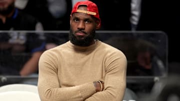 Mar 10, 2025; Brooklyn, New York, USA; Los Angeles Lakers forward LeBron James (23) watches from the bench during the fourth quarter against the Brooklyn Nets at Barclays Center. Mandatory Credit: Brad Penner-Imagn Images