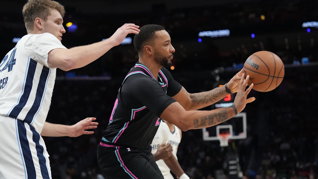 Feb 21, 2026; Miami, Florida, USA;  Miami Heat guard Norman Powell (24) passes the ball as Memphis Grizzlies guard Cam Spencer (24) defends during the second half at Kaseya Center. Mandatory Credit: Jim Rassol-Imagn Images