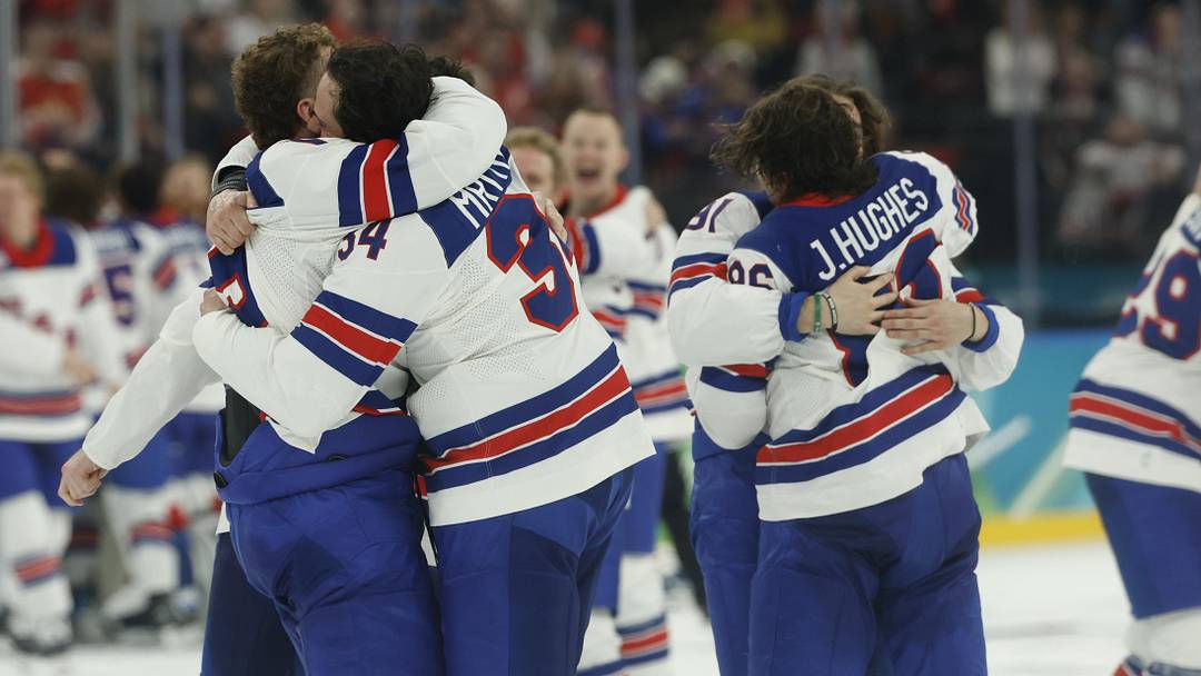 Feb 22, 2026; Milan, Italy; Team USA players celebrate after a golden goal in overtime by Jack Hughes #86 of Team United States during the Milano Cortina 2026 Olympic Winter Games at Milano Santagiulia Ice Hockey Arena. Mandatory Credit: Geoff Burke-Imagn Images