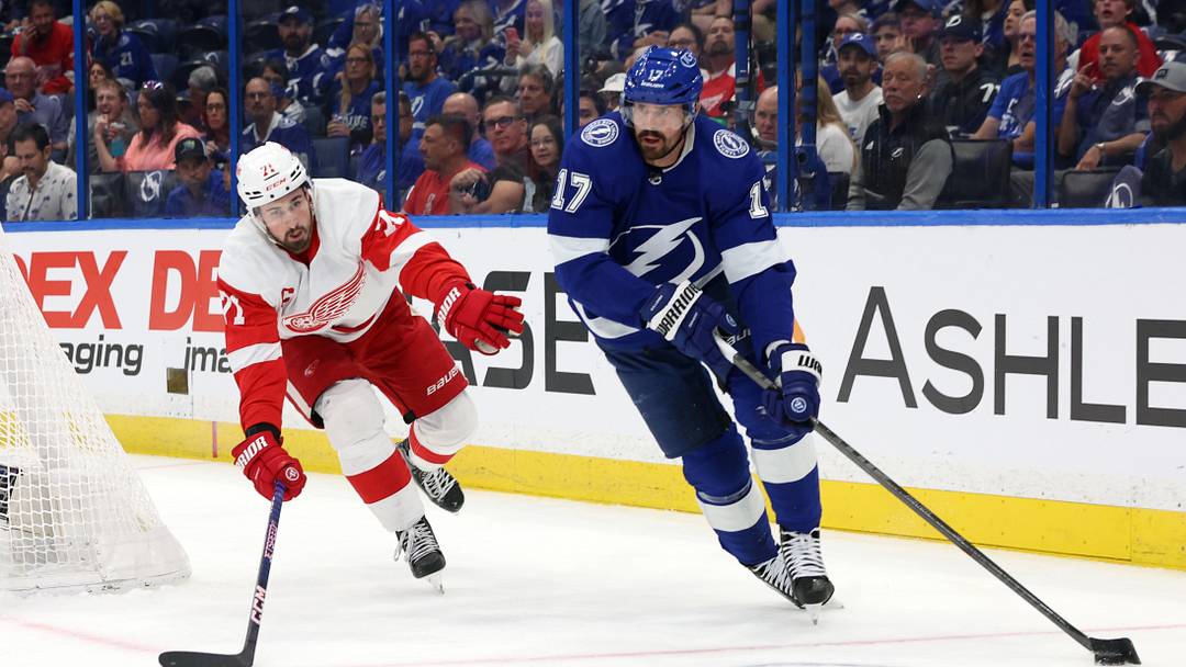Apr 13, 2023; Tampa, Florida, USA; Tampa Bay Lightning left wing Alex Killorn (17) skates with the puck as Detroit Red Wings center Dylan Larkin (71) defends during the first period at Amalie Arena. Mandatory Credit: Kim Klement-Imagn Images