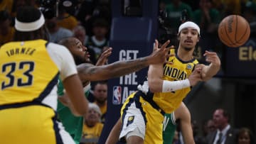 May 25, 2024; Indianapolis, Indiana, USA; Indiana Pacers guard Andrew Nembhard (2) passes the ball to center Myles Turner (33) against the Boston Celtics during the fourth quarter of game three of the eastern conference finals in the 2024 NBA playoffs at Gainbridge Fieldhouse. Mandatory Credit: Trevor Ruszkowski-USA TODAY Sports